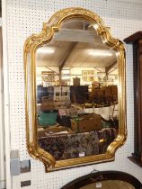 A contemporary French style gilt and cream decorated shaped rectangular wall mirror, 98 x 65.5cm