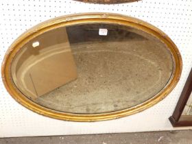 An early 20th century giltwood framed bevelled oval wall mirror, 57.5 x 81.5cm