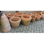 A collection of eleven various terracotta cylindrical tapering planters; together with a