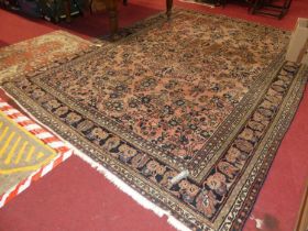 A Persian woollen faded red ground Tabriz rug, the central Tree of Life decoration within trailing