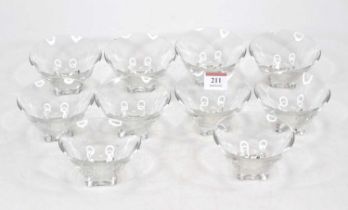 A set of ten French clear glass bowls, each of circular tapered form on shaped square base, with