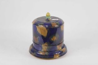 A Victorian majolica glazed cheese dome and cover, on a mottled blue/brown ground with acorn finial,