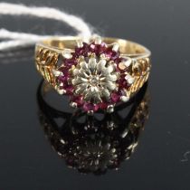 A Victorian style ruby and diamond point set flowerhead cluster ring, the shoulders each with leaf