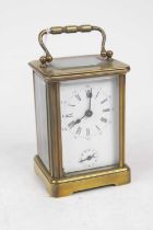 A 20th century lacquered brass cased carriage clock, having an enamelled dial with Roman numerals,