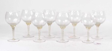 A set of eight Murano glass goblets, each having a wrythen moulded bowl on a further moulded stem