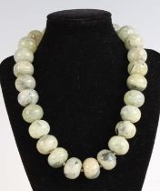 A beaded and polished prehnite necklace, with white metal clasp, length 46cm
