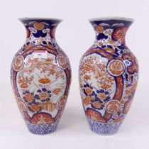 A pair of Imari porcelain vases, each of shouldered baluster form, typically decorated with