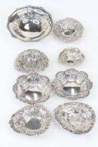 A George V silver bonbon dish, of pierced circular form with raised border, together with seven