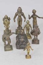 A collection of eight Indian cast bronze and brass deity figures, to include Lord Krishna, Radha and