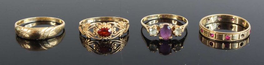 A 9ct gold amethyst and paste three stone ring, together with three other modern 9ct gold rings,