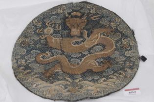 A Chinese silk embroidered badge panel, with a five-claw dragon clutching a pearl in gold thread