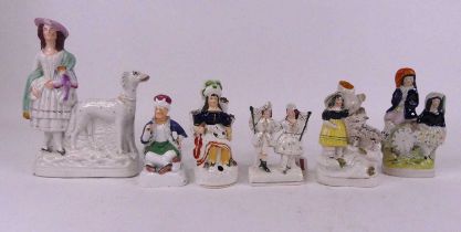 A Staffordshire pottery figure group, of a lady standing beside a greyhound, height 25cm, together