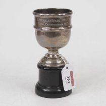 A George V silver trophy goblet with presentation inscription, upon an ebonised plinth, 2.2oz
