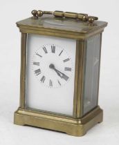 An early 20th century lacquered brass cased carriage clock, having an enamelled dial with Roman