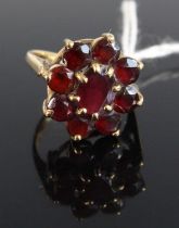 A modern 9ct gold and garnet set flower head cluster ring, setting dia.17mm, 3.7g, size K