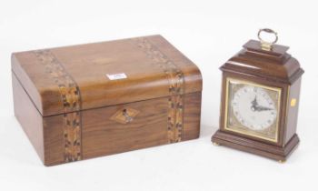 A walnut cased mantel clock in the 18th century style, having a silvered chapter ring with Roman