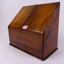 A Victorian walnut table top stationery cabinet opening to reveal a fitted interior, height 26cm