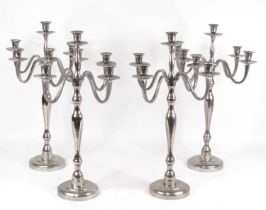 A set of four chrome plated five-sconce table candelabra, h.59cm
