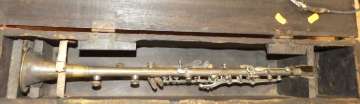 A brass and base metal part clarinet and a brass trumpet marked 1911, in fitted wooden case, case