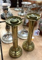 A pair of early 20th century brass candle lanterns, each on loaded base, h.26cm (lacking shades);