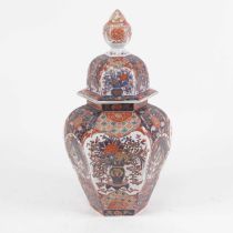 An early 20th century vase of cover, of hexagonal baluster form, decorated in the imari palette with