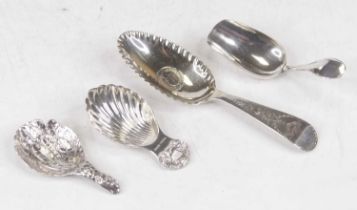 An Elizabeth II silver caddy spoon, having a shell shaped bowl with cast shell terminal; together