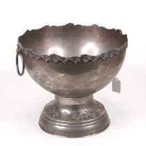A large plated punch bowl the rim cast with leaves and berries, having lion mask ring handles,