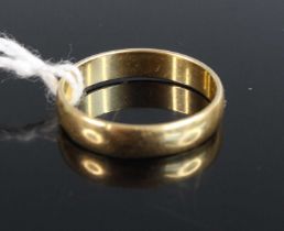 A modern yellow metal court shaped wedding band, stamped 750, 3.2g, size O