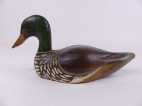 A carved wooden polychrome painted decoy in the form of a duck, length 31cm