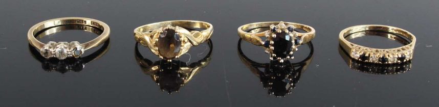 Four various modern 9ct gold dress rings to include sapphire cluster example, and a diamond three