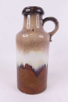 A mid 20th century West German pottery vase, having a single loop handle and recessed neck with a