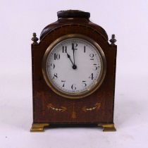 An Edwardian mahogany cased mantel clock, the enamel dial showing Arabic numerals with inlaid swag