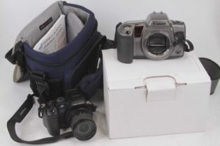 A Konica Minolta Dimage A200 digital camera; together with a Canon camera body; travelling case