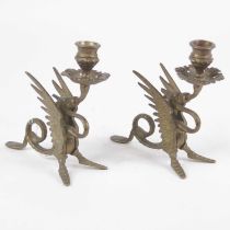 A pair of cast brass table candlesticks, each having a single sconce supported by a griffin, the
