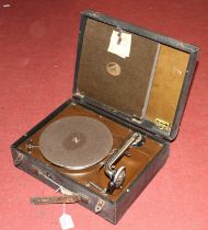 A His Master's Voice portable wind-up gramophone having a faux leather clad exterior and hinge lid