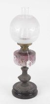A Victorian oil lamp, having an opalescent etched glass globular shade above a purple tinted glass