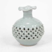 A Chinese celadon glazed vase, of squat circular form, having a frilled everted rim and