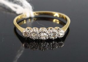 An 18ct gold platinum and diamond five stone ring, arranged as five illusion set small graduated