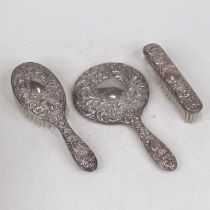 A Victorian style filled silver backed hand mirror; together with a matching hairbrush and clothes