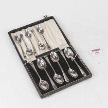 A set of six George V silver teaspoons, with bright cut engraved decoration, in fitted leather case;