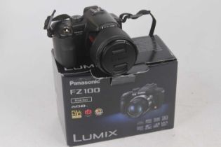 A Panasonic DMC-FZ100 digital camera, boxed with charger; together with a Panasonic DMC-FZ50 digital