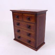 An Edwardian mahogany boxwood and ebony strung apprentice chest of two short over three long