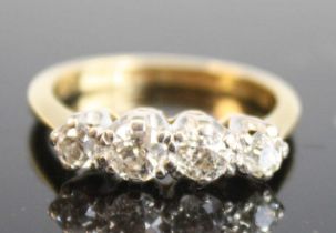 An 18ct yellow and white gold diamond four-stone ring, comprising four graduated Old European cut
