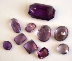 A collection of loose vari-cut amethyst stones, the smallest oval cut measuring approx 8.9 x 7.1 x