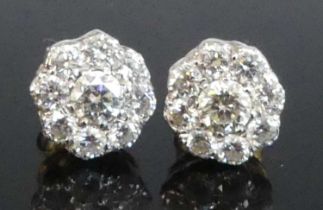 A pair of yellow and white metal diamond circular cluster stud earrings, each featuring nine round