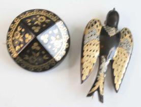 Two pique tortoiseshell brooches, one in the form of a swallow with yellow and white metal detail to