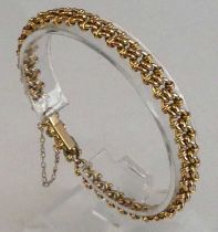 A yellow metal fancy interlocking circular link bracelet, with box clasp and safety chain, length