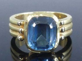 A yellow metal blue topaz heavy dress ring, featuring an approx 10.5 x 8.6mm octagonal cut blue