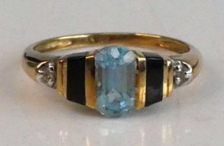 A yellow metal, blue topaz and diamond Art Deco style ring, featuring a centre oval blue topaz