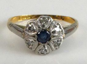 A yellow and white metal, sapphire and diamond circular cluster ring, featuring a centre round